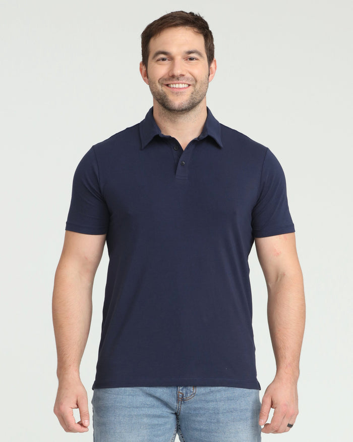 Man wearing navy short-sleeve polo shirt with collar and button placket, paired with light blue jeans.
