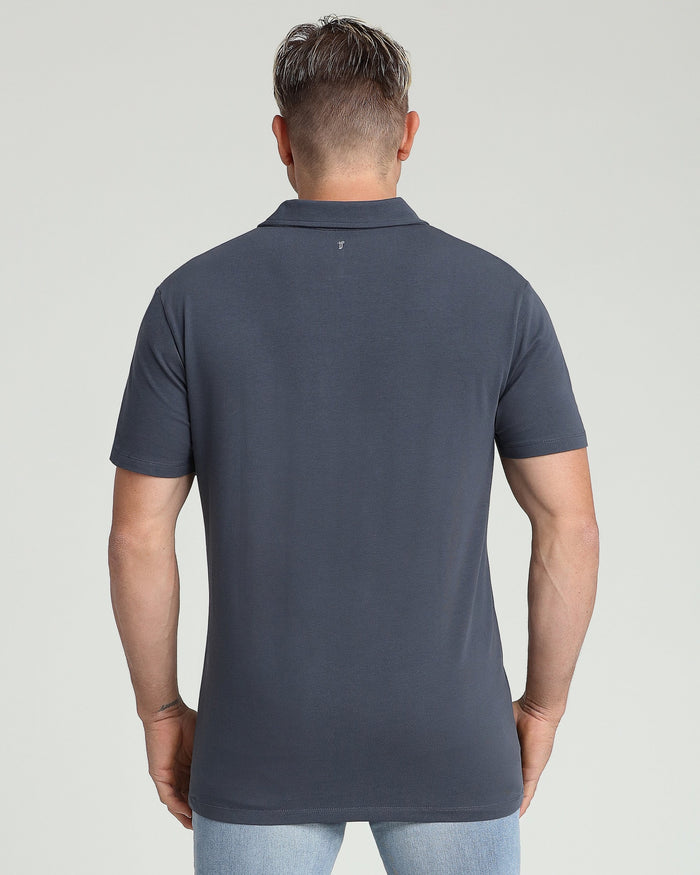 Man wearing navy blue short-sleeve polo shirt with collar, shown from back view.