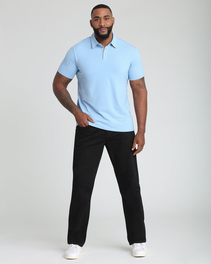 Man wearing light blue short-sleeve polo shirt with collar and button placket, paired with black pants.
