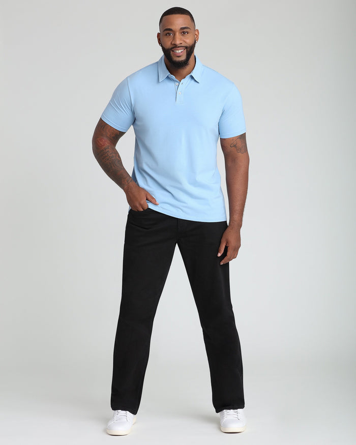 Man wearing light blue short-sleeve polo shirt with collar and button placket, paired with black pants.