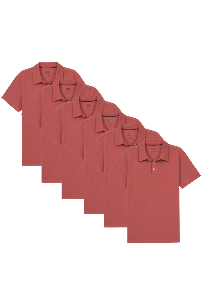 Six nantucket red polo shirts with short sleeves and collar, arranged in a staggered display.