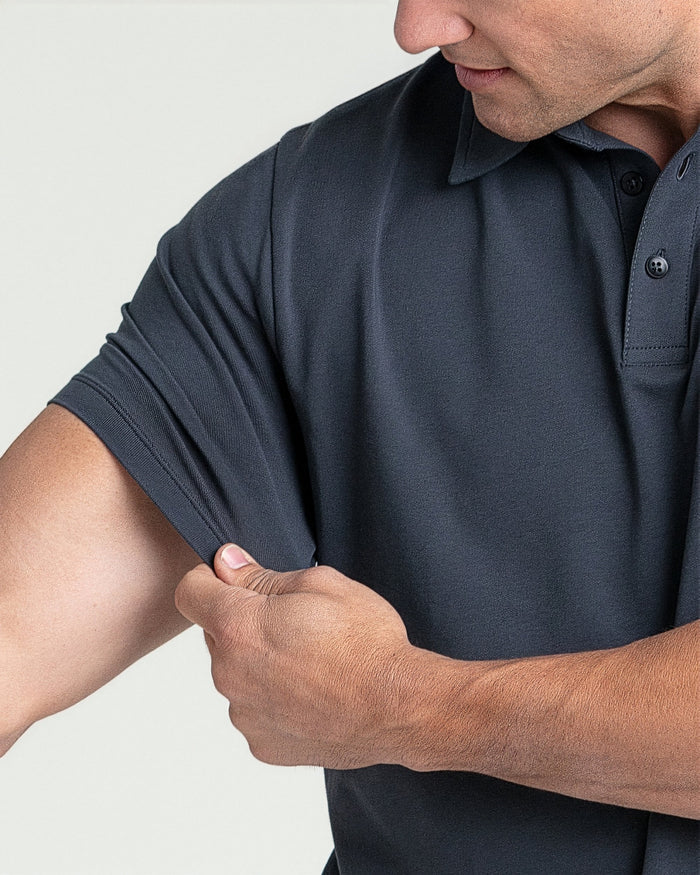 Man wearing steel gray short-sleeve polo shirt with button collar and visible stitching detail.