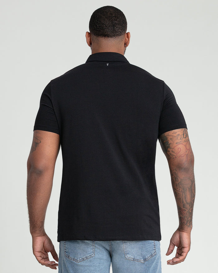 Man wearing black short-sleeve polo shirt with collar, shown from back view.
