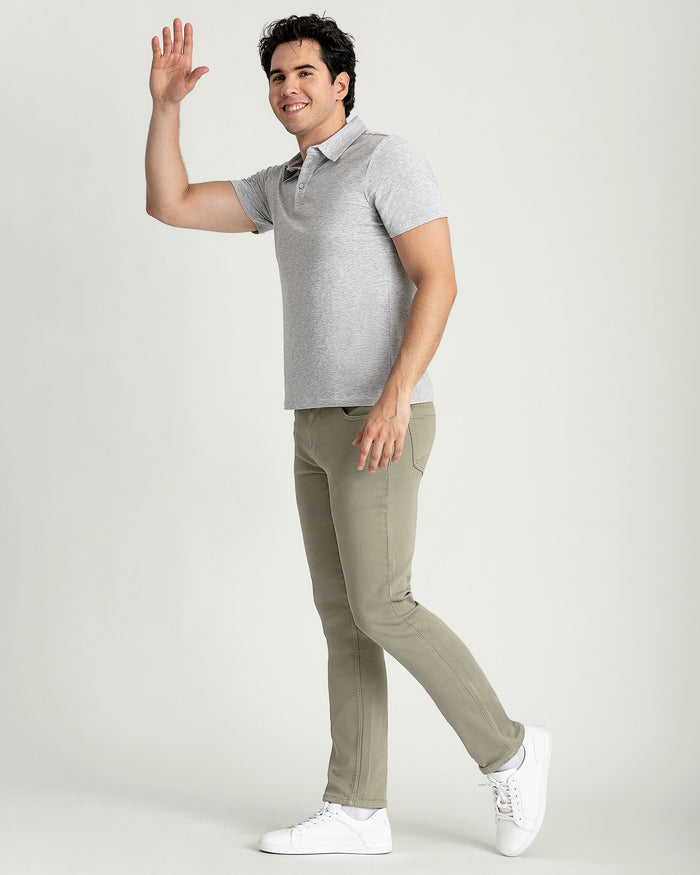 Man wearing heather grey short-sleeve polo shirt with khaki pants and white sneakers.