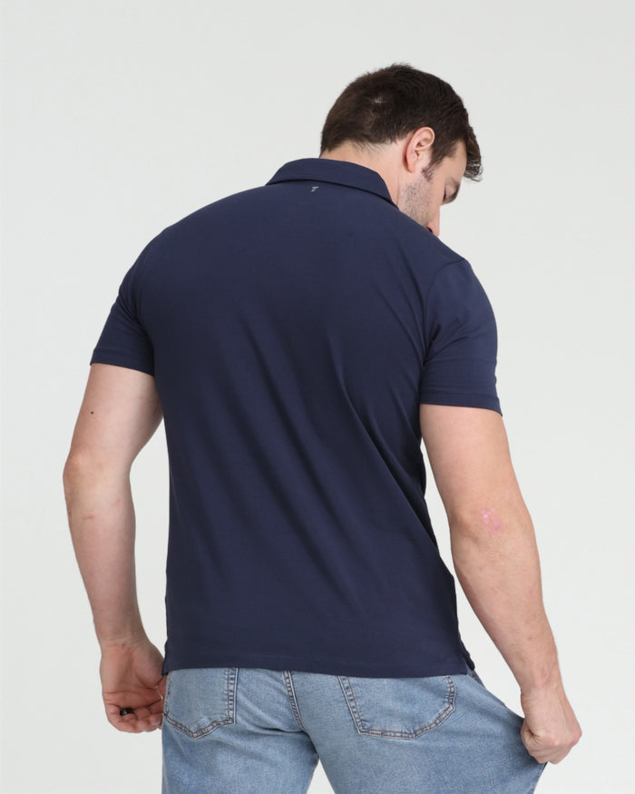 Man wearing navy polo shirt with short sleeves, shown from back view against white background.
