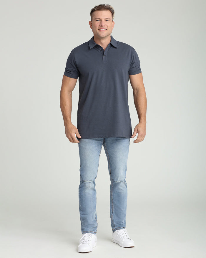 Man wearing steel gray short-sleeve polo shirt with collar and button placket, paired with light blue jeans.