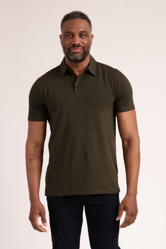 Man wearing olive-green polo shirt with collar and button placket, paired with dark navy pants.