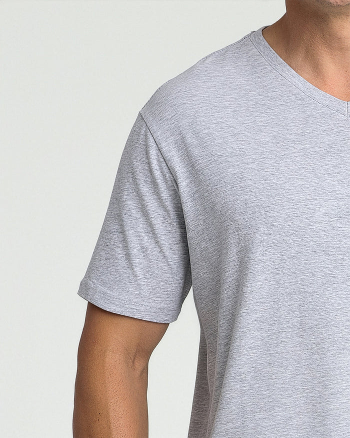 Heather grey v-neck t-shirt with short sleeves on a model against a neutral background.