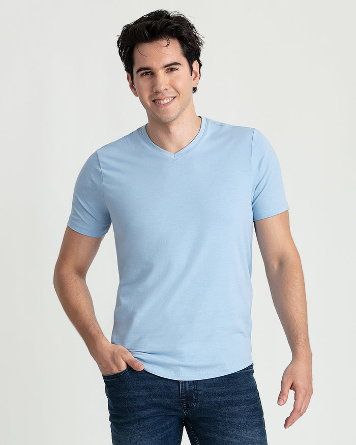 Man wearing light blue v-neck short-sleeve t-shirt with dark jeans.