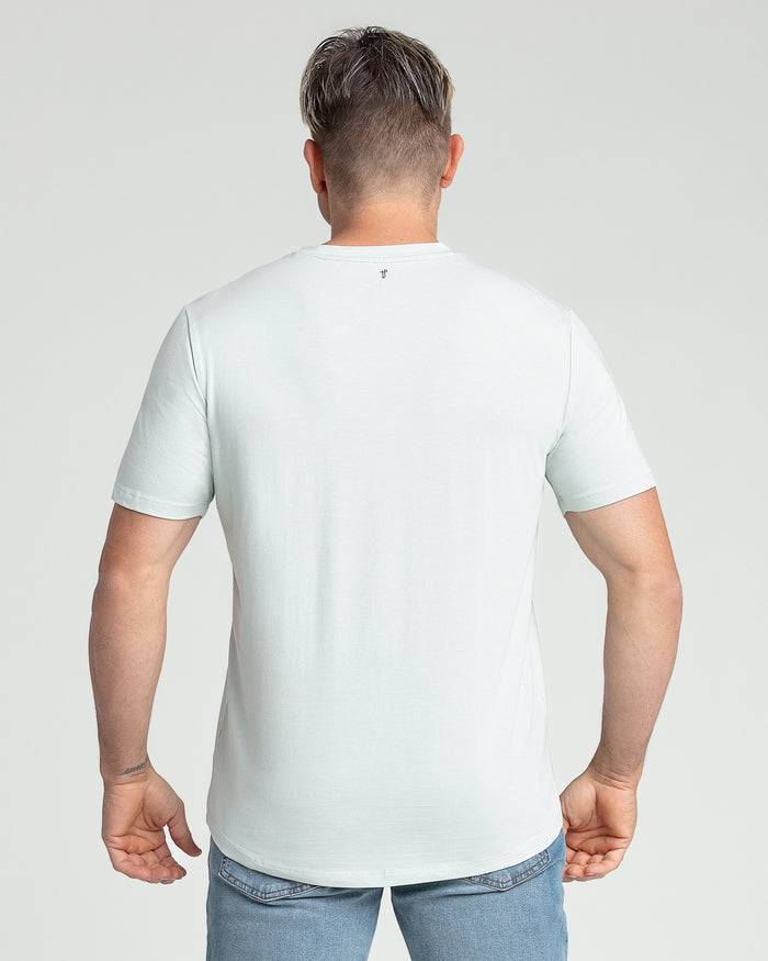 Man wearing mint green v-neck short-sleeve t-shirt, back view.