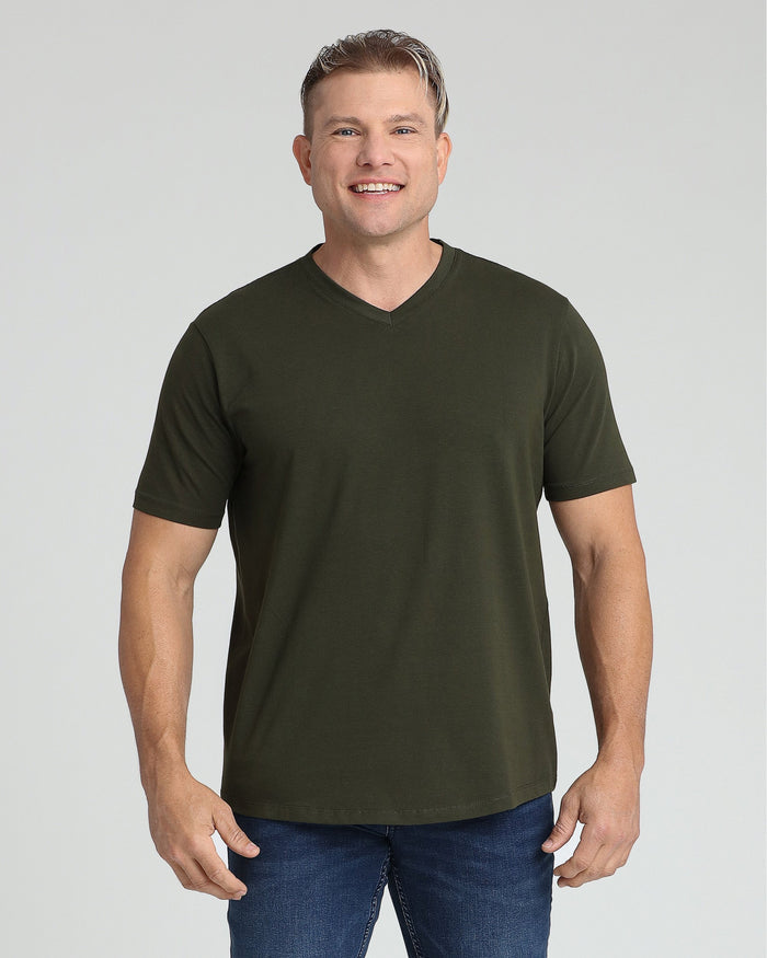 Man wearing olive v-neck short-sleeve t-shirt with blue jeans.