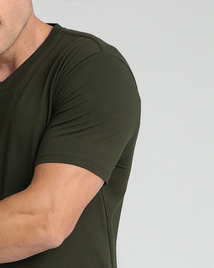 Man wearing olive green v-neck t-shirt with short sleeves.
