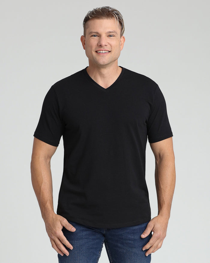 Man wearing black v-neck short-sleeve t-shirt with blue jeans.