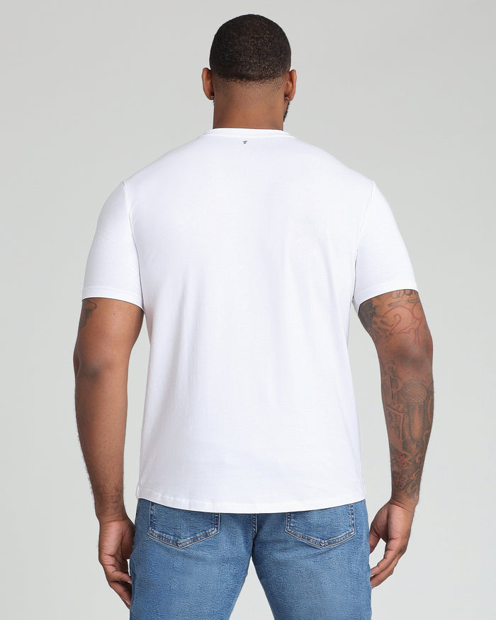 White v-neck t-shirt with short sleeves, shown from back view on model wearing blue jeans.