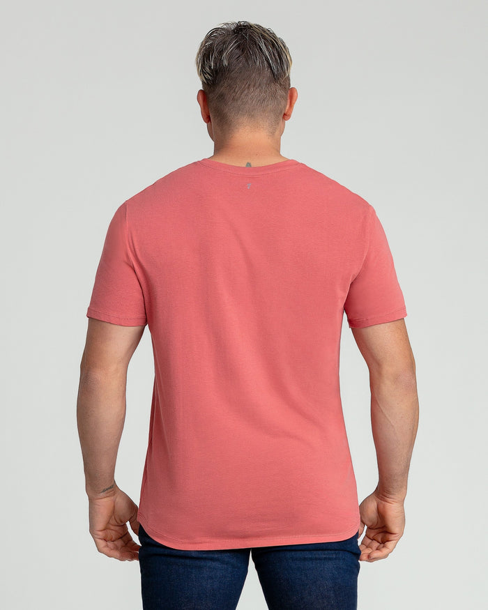 Man wearing a nantucket red v-neck t-shirt, shown from back view.