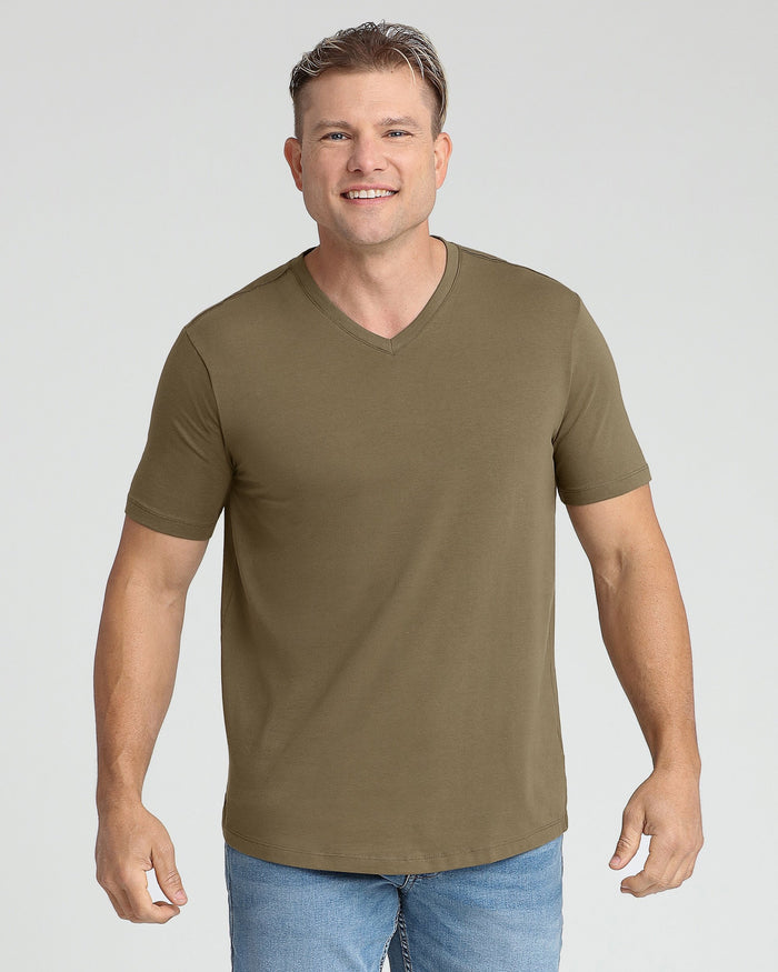 Man wearing military olive v-neck short-sleeve t-shirt with blue jeans.