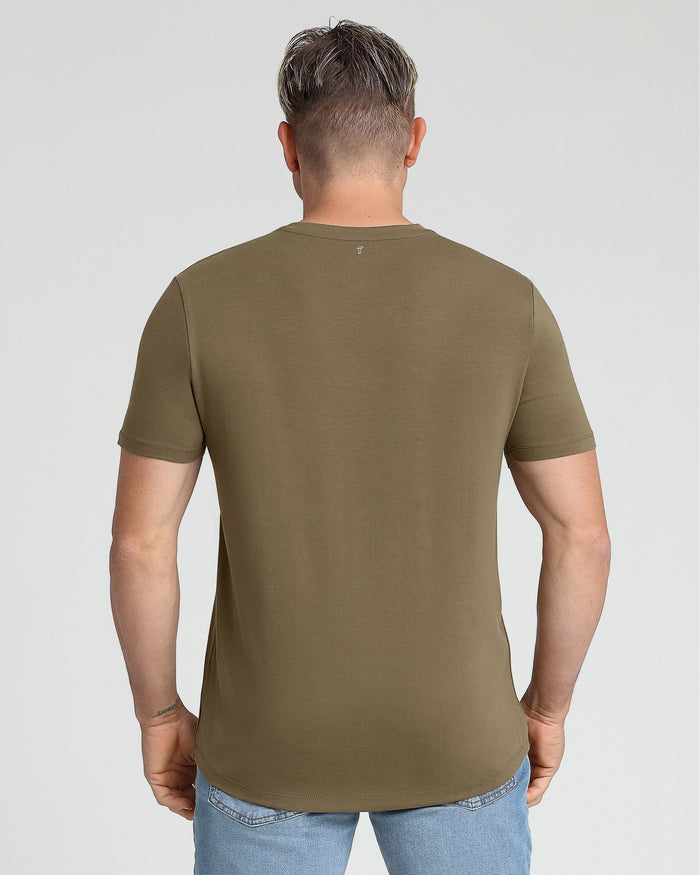Man wearing military olive V-neck t-shirt, shown from back, paired with light blue jeans.