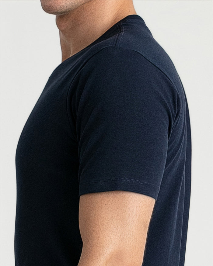 Navy v-neck t-shirt on man shown from side angle.