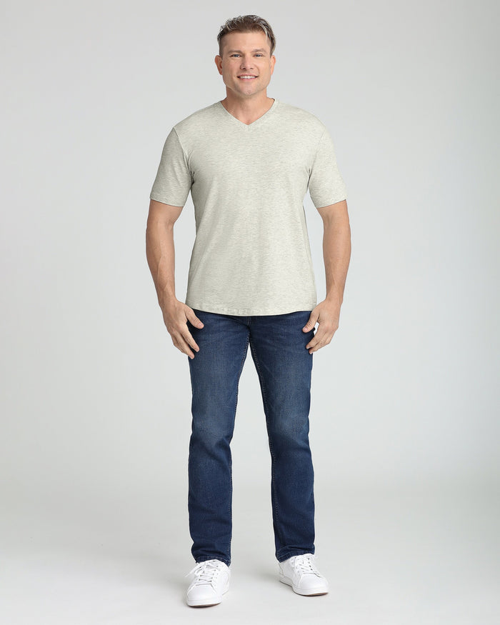Oatmeal heather v-neck t-shirt with short sleeves on male model wearing dark jeans.