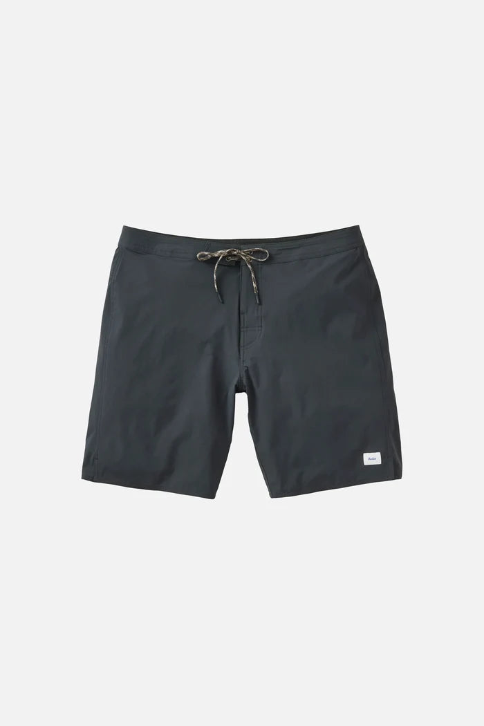 Katin OTG Crest Surf Trunk in Black Wash laid flat on a light grey background, showing the dark charcoal grey board short with a braided drawstring waistband and a small white Katin label on the lower left leg