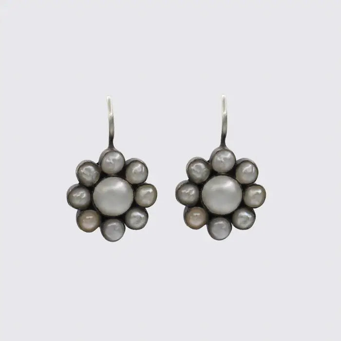 A pair of oxidized sterling silver pearl flower drop earrings with a vintage feel.