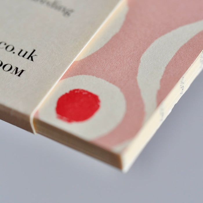 Product packaging with a red dot and text on a light background