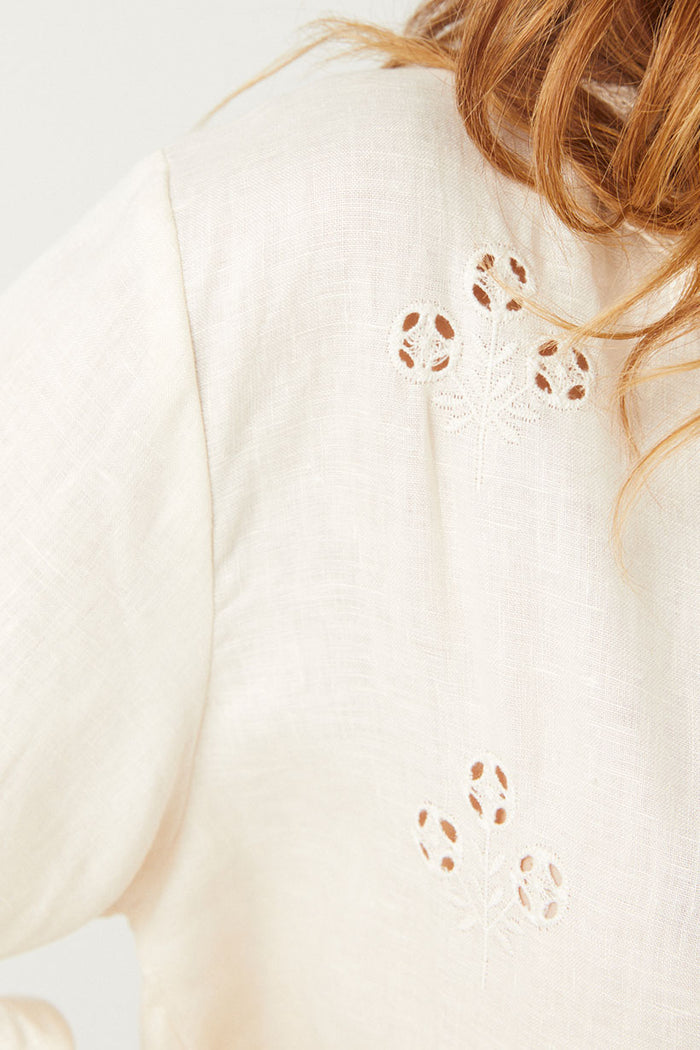 Close-up of cutwork floral eyelet embroidery on antique cream linen back panel of Pfeiffer Shirt