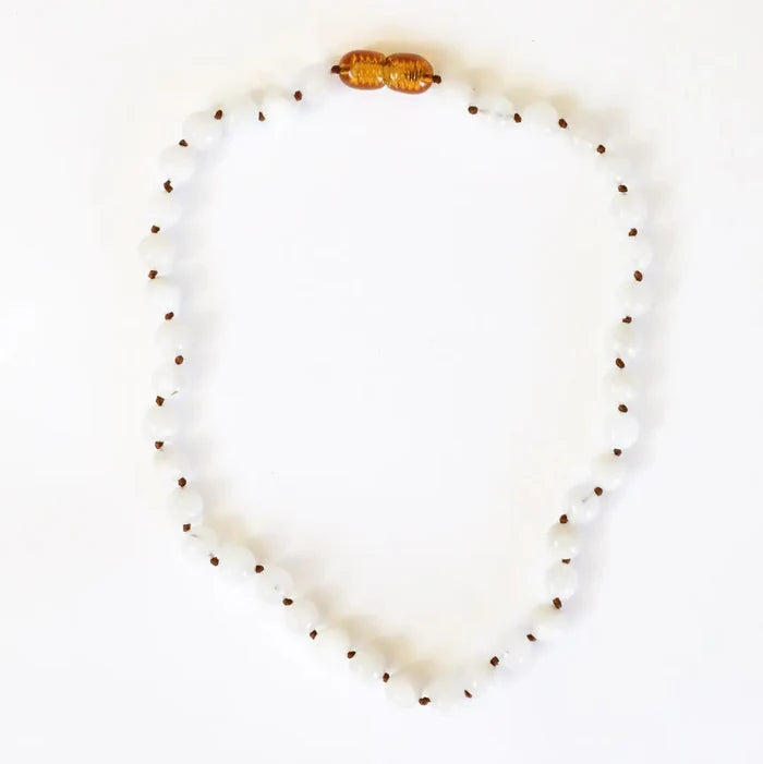 CanyonLeaf Pure Gemstone + Moonstone Necklace — a hand-knotted necklace of smooth translucent white moonstone beads with dark brown knots between each bead and a honey amber screw clasp, laid flat on a white background