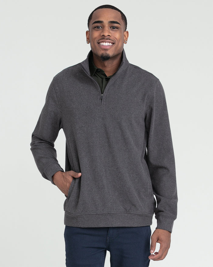 Charcoal heather quarter zip pullover with ribbed cuffs and kangaroo pocket, worn with navy pants.