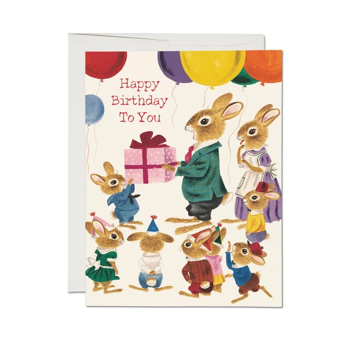 Birthday card with illustrated bunnies and balloons on a white background