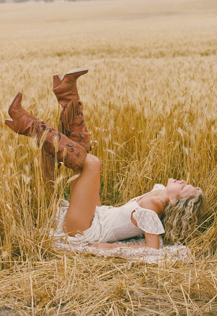 Spell women's Sannah Fringe Boot Vintage Tan leather suede tassel cowboy boot worn in wheat field