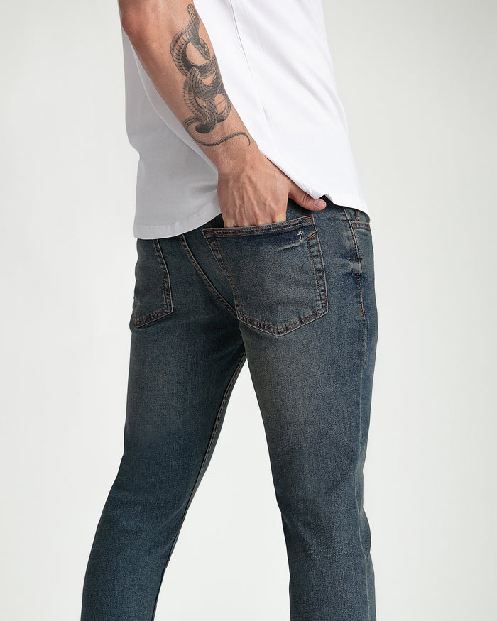 Men's dark tinted skinny fit cowboy jeans with five-pocket styling and contrast stitching.