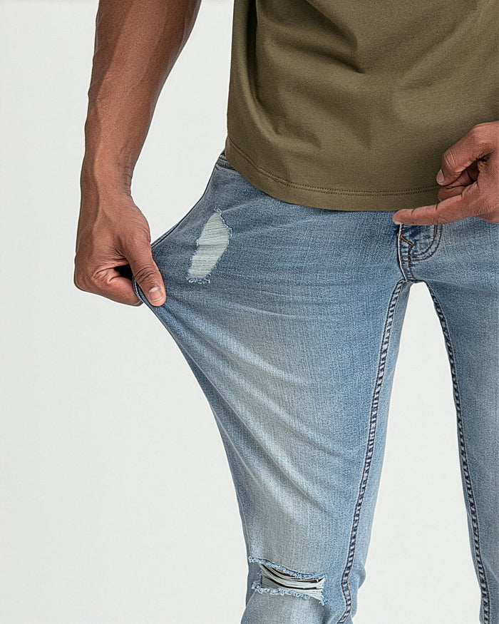 Light blue skinny fit jeans with ripped details at the thigh and knee.