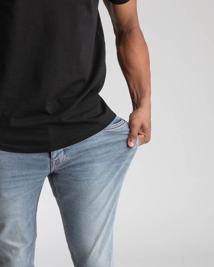 Light blue skinny fit jeans with a striped waistband, worn with a black t-shirt.