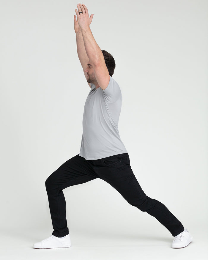 Man wearing black slim fit jeans with white sneakers, demonstrating the fit and silhouette.
