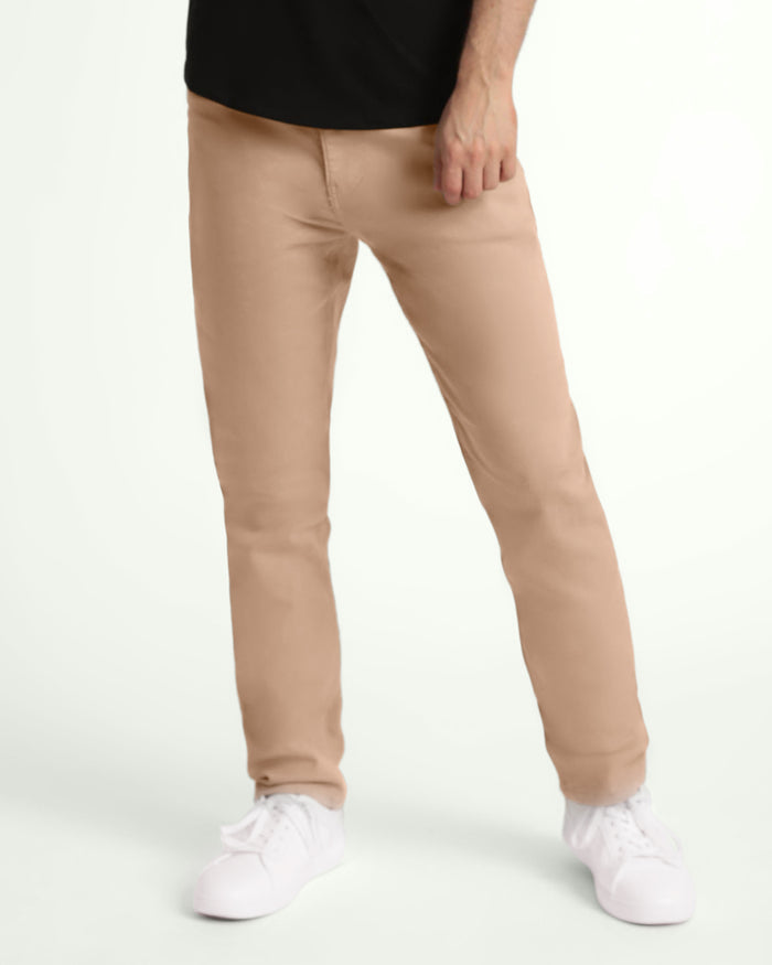 Light khaki slim fit pants on model wearing black shirt and white socks.