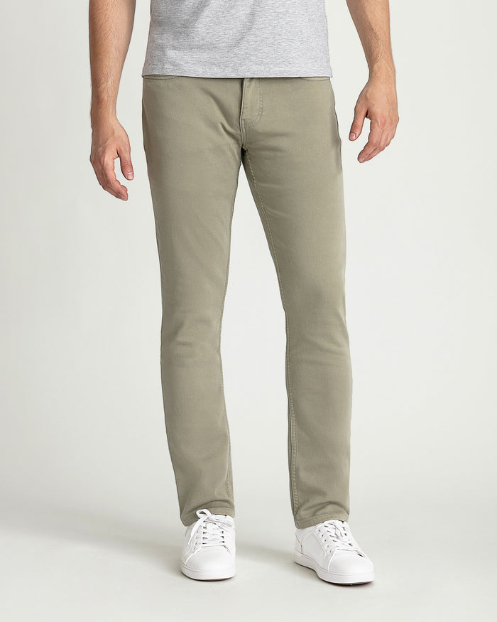 Man wearing light sage slim fit chinos with gray t-shirt and white sneakers.