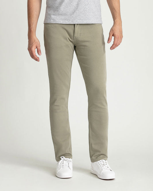 Man wearing light sage slim fit chinos with gray t-shirt and white sneakers.
