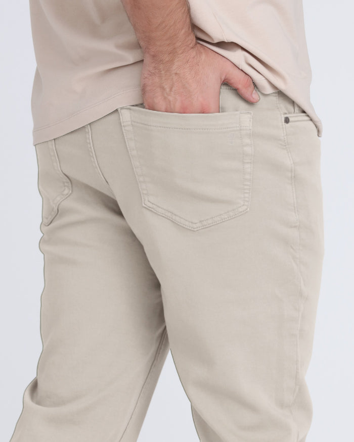 Light grey slim fit pants with back pocket detail and zip fly closure.