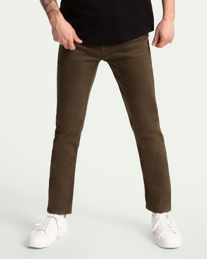 Man wearing black t-shirt and slim fit olive-colored pants with white sneakers.