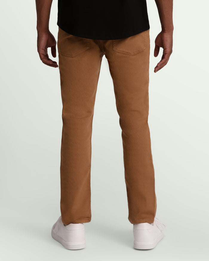 Brown slim fit pants with five-pocket styling and visible stitching detail on back pockets.