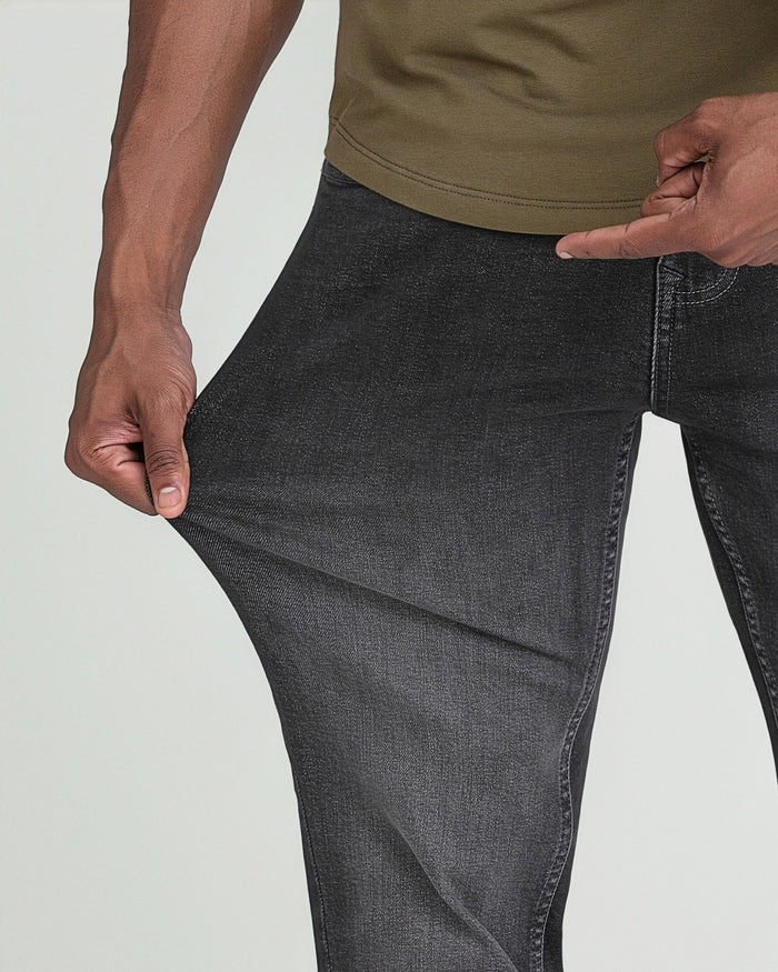 Man wearing grey Axel slim thick fit jeans with olive green shirt, showing fabric texture and fit.