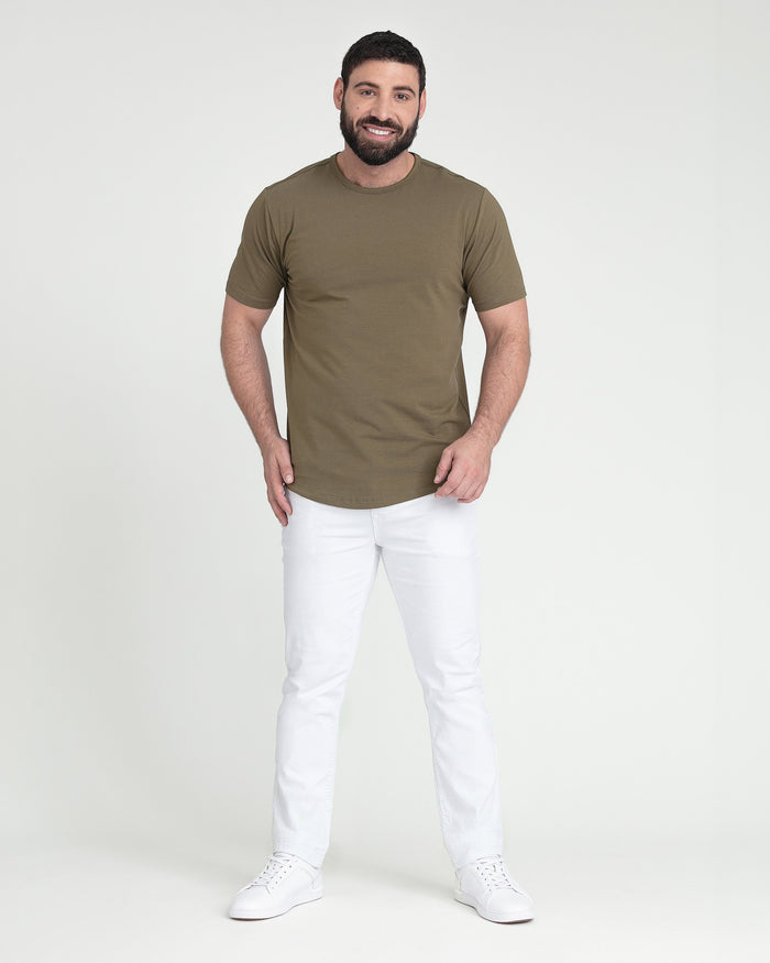 Man wearing olive green short-sleeve t-shirt with white pants and white sneakers.