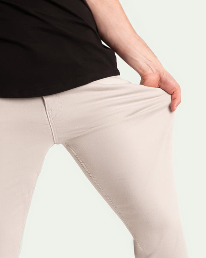 Light grey pants with fitted waistband and tapered leg, shown on model wearing black top.
