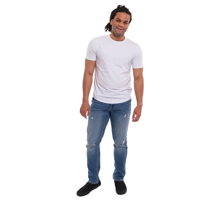Man wearing lavender short-sleeve t-shirt and medium blue ripped jeans with knee tears.