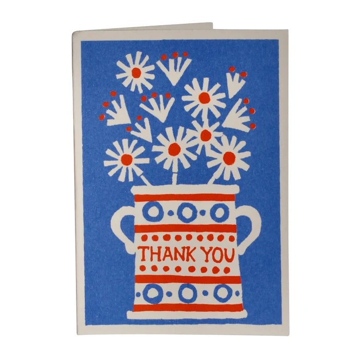 Greeting card with floral design and 'Thank You' text on a blue background