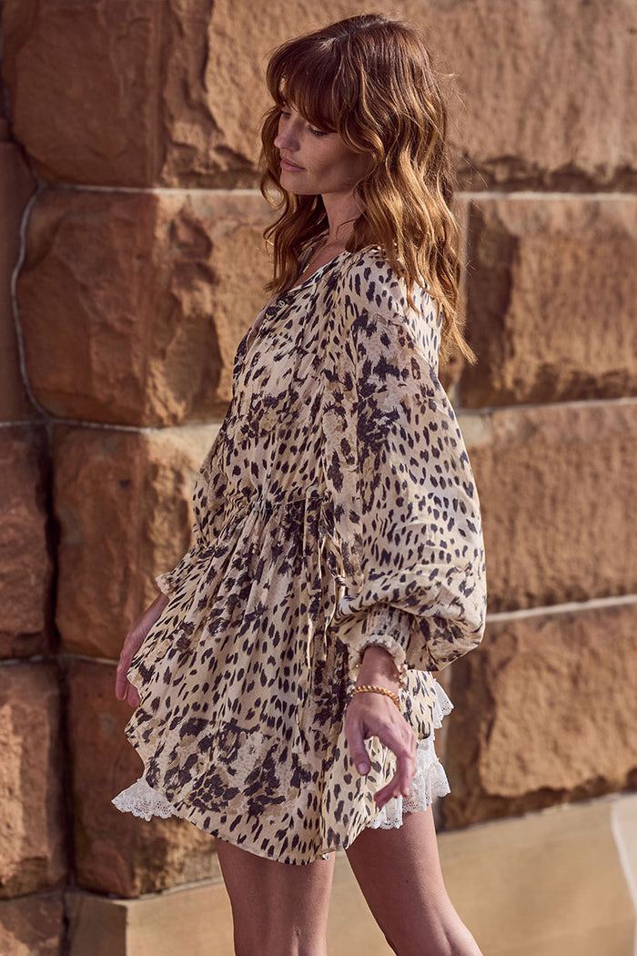 Side view of Snow Leopard Asymmetric Blouse showing lace hem trim, shirred cuffs and side tie detail