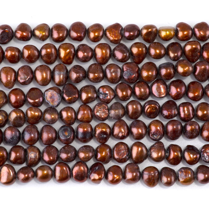 This is a Dakota Stones 5-7mm Special Price Freshwater Pearl Copper Gemstone strand with irregular beads in 15-16 inch strand.