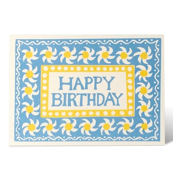 Birthday card with blue border, white flowers, and yellow centers on a white background