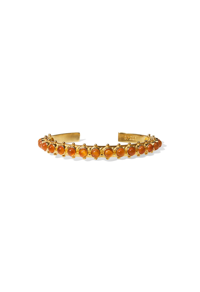 Front view of gold-plated brass cuff bracelet with row of carnelian stones and granule detail settings